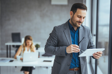 Businessman Using Digital Tablet in Modern Office Setting