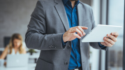 Business Professional Using a Tablet Device in Modern Office Setting