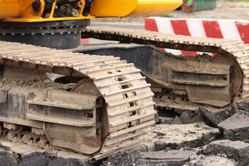 Close-up of excavator track. Close-up of part of construction excavator, tracked vehicle. Repair work in the city. Special equipment. Equipment at the construction site. Heavy construction equipment