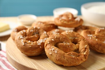 Tasty pretzels with salt on table, closeup