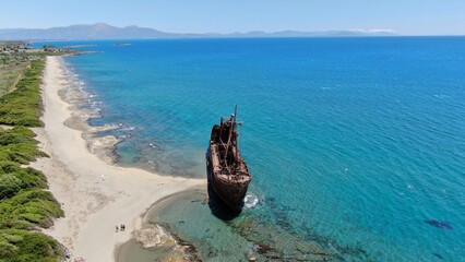 Abandoned shipwreck Dimitrios rests on a serene beach surrounded by clear blue waters in Gytheio...