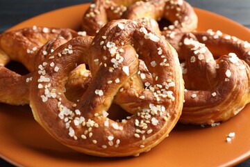 Tasty pretzels with salt on table, closeup