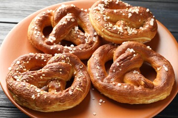 Tasty pretzels with salt on table, closeup