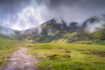 Experience the stunning beauty of a lush mountain landscape with vibrant greenery and enchanting clouds, perfect for nature lovers and adventure seekers, Kerry, Ireland