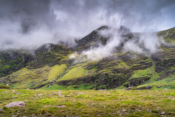 Behold a breathtaking view of a misty Carrauntoohil mountain landscape adorned with vibrant green hills and swirling clouds, truly ideal for various nature themed creative projects, Kerry, Ireland