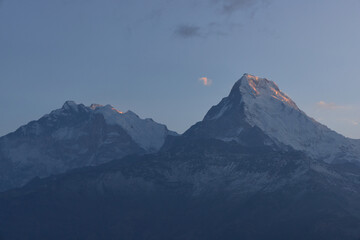 As dawn breaks over the South Annapurna region, the majestic peaks are bathed in golden light,...