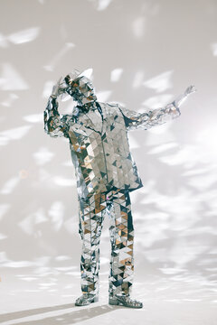 Fototapeta Mirror man dancing and adjusting hat in white studio