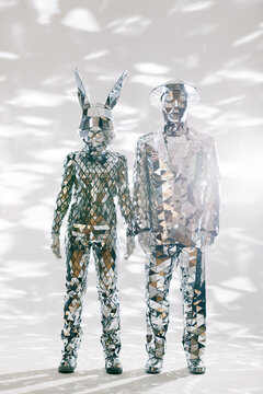 Fototapeta Mirror dancers wearing reflective costumes holding hands