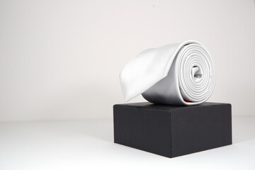 white tie rolled on gift box close up shot with copy space 