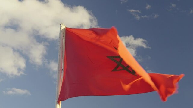 Moroccan Flag Waving Against Clear Blue Sky
