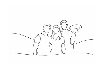 Three friends smiling together holding a rugby ball