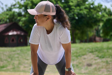 Woman in Sportswear Resting Outdoors During Fitness Exercise