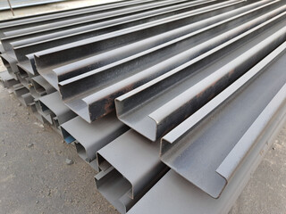 C channel steel or Light-edged channel steel for construction.  C-shaped steel structure.Stacked of Steel Angled Bar