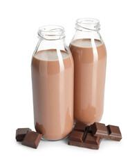 Tasty chocolate milk in glass bottles and pieces isolated on white