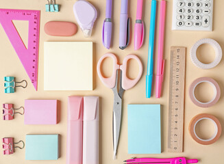 Pens and other stationery on beige background, flat lay