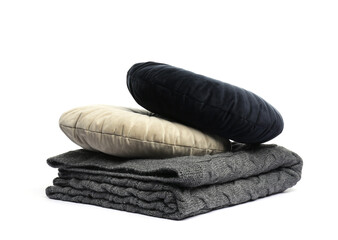 Folded grey blanket and pillows isolated on white