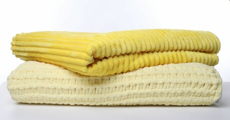 Two folded woolen blankets on white background