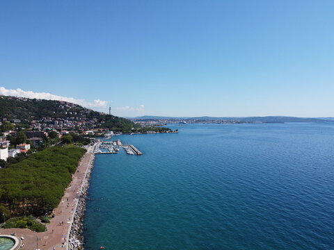 A stunning drone view of Trieste from Barcola, showcasing the city's coastline, historic buildings, and Adriatic charm under a clear northern Italian sky.