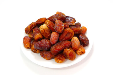 A full plate of dates fruits closeup shot  on white background 
