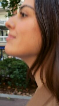 Vertical Video: Empowered Young Woman Walking Confidently Through City Streets