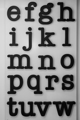 Close-up of an eye chart displaying multiple letters used by optometrists to assess visual acuity. This clear and sharp image symbolizes eye care, health, and vision testing.

