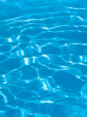 blue pool background, with the sun's rays illuminating the bottom of the pool.