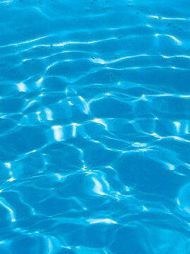 blue pool background, with the sun's rays illuminating the bottom of the pool.
