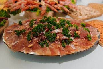 Luxurious Charcuterie Platter with Prosciutto, Shrimp, and Garnishes, Appetizers and Festive Food Display.