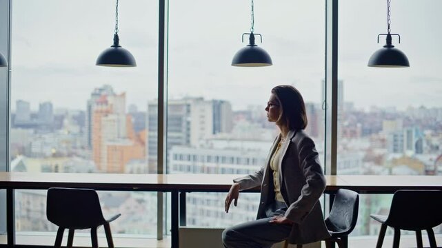Ceo woman watching panoramic window office zoom on. Rich businesswoman dreaming