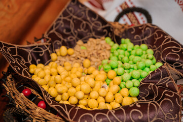 Traditional Arabic Sweets Assortment in Woven Basket: Golden & Green Candies, Festive Food, Middle Eastern Cuisine, Decorative Still Life, Rich Textures