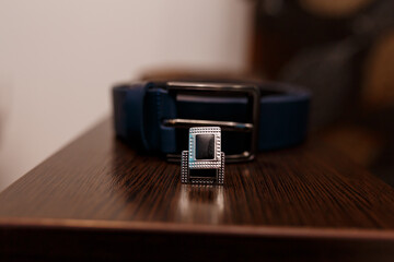 Blue Leather Belt with Silver Buckle on Wood Table: Wedding Day Accessory, Groom Fashion, Stylish...