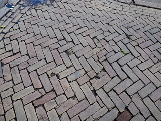 Random pattern stone pavement with irregular shaped blocks creating natural organic texture for urban walkways
