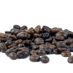 close up of coffee beans on white background