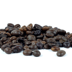 close up of coffee beans on white background