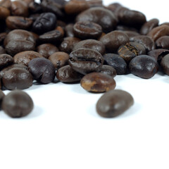close up of coffee beans on white background