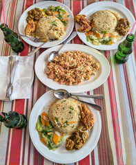 Fried rice with beef curry, chicken fry, vegetable salad, cashew nut salad, and cold drinks 