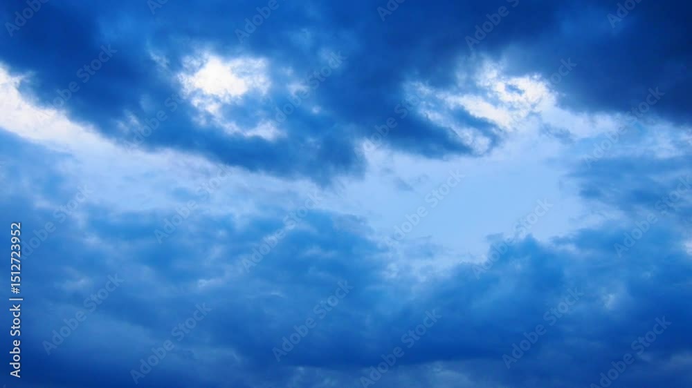 Aufkleber Witness the beautiful transformation of a sky dominated by blue clouds, creating a captivating dance of color and light as daylight fades into evening. Nature artistry unfolds before your eyes