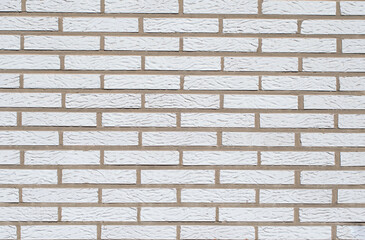 White brick background, textured surface showing spoon masonry, ideal for various design and architectural projects,