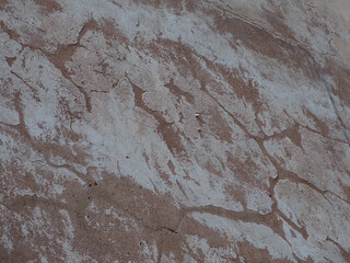 Weathered stone wall texture showing natural aging patterns and erosion effects
