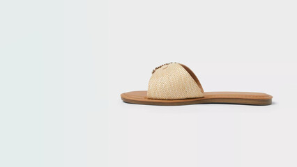 Stylish beige sandal with shell embellishment perfect for summer outings and beach wear in a modern...