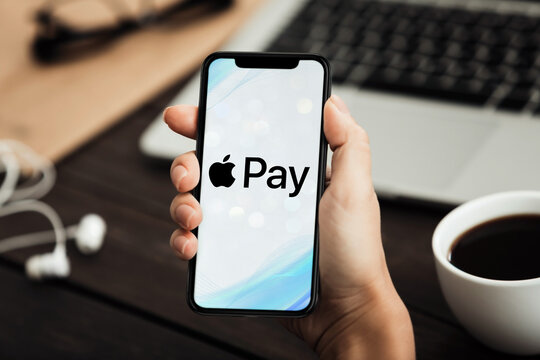 Businessman using apple pay on smartphone for contactless payment
