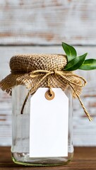 Fototapeta premium Empty glass jar with burlap lid and blank tag