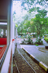 Obraz premium Scenic View of City Park from Open-Air Train Window