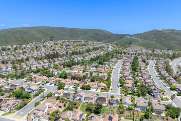 Aerial view of San Marcos neighborhood with houses and street during sunny day, South California, USA.
