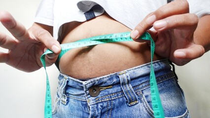 A man measures his waist circumference with a measuring tape. Illustration of obesity.