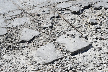Destroyed cement with rebar exposed.