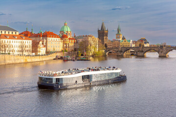 View of Charles Bridge and sightseeing boat on Vltava River in Prague, Czech Republic