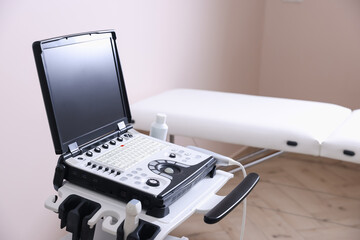 Modern ultrasound machine and examination bed in clinic