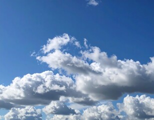 Fototapeta premium Fluffy clouds against a vibrant blue sky (1)