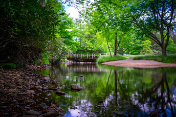 river in the mountains with bridge
